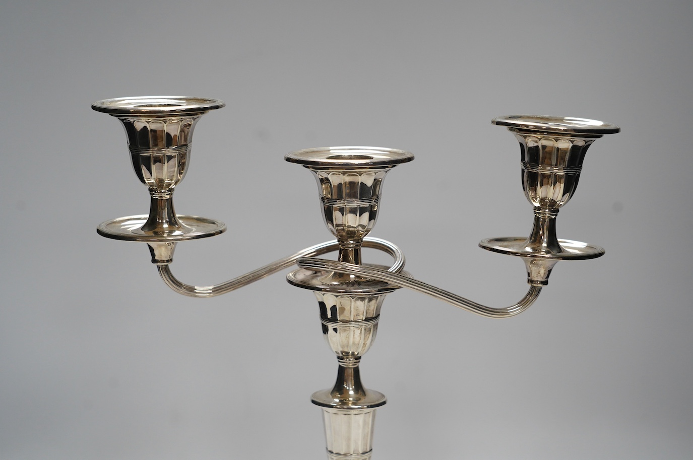 A late Victorian silver two branch, three light candelabrum, Edward Hutton, London, 1891, height 30.7cm, weighted. Condition - fair